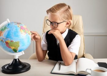 Boy examining globe to explore the world