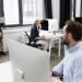 Group of business people talking to each other while working together at the office